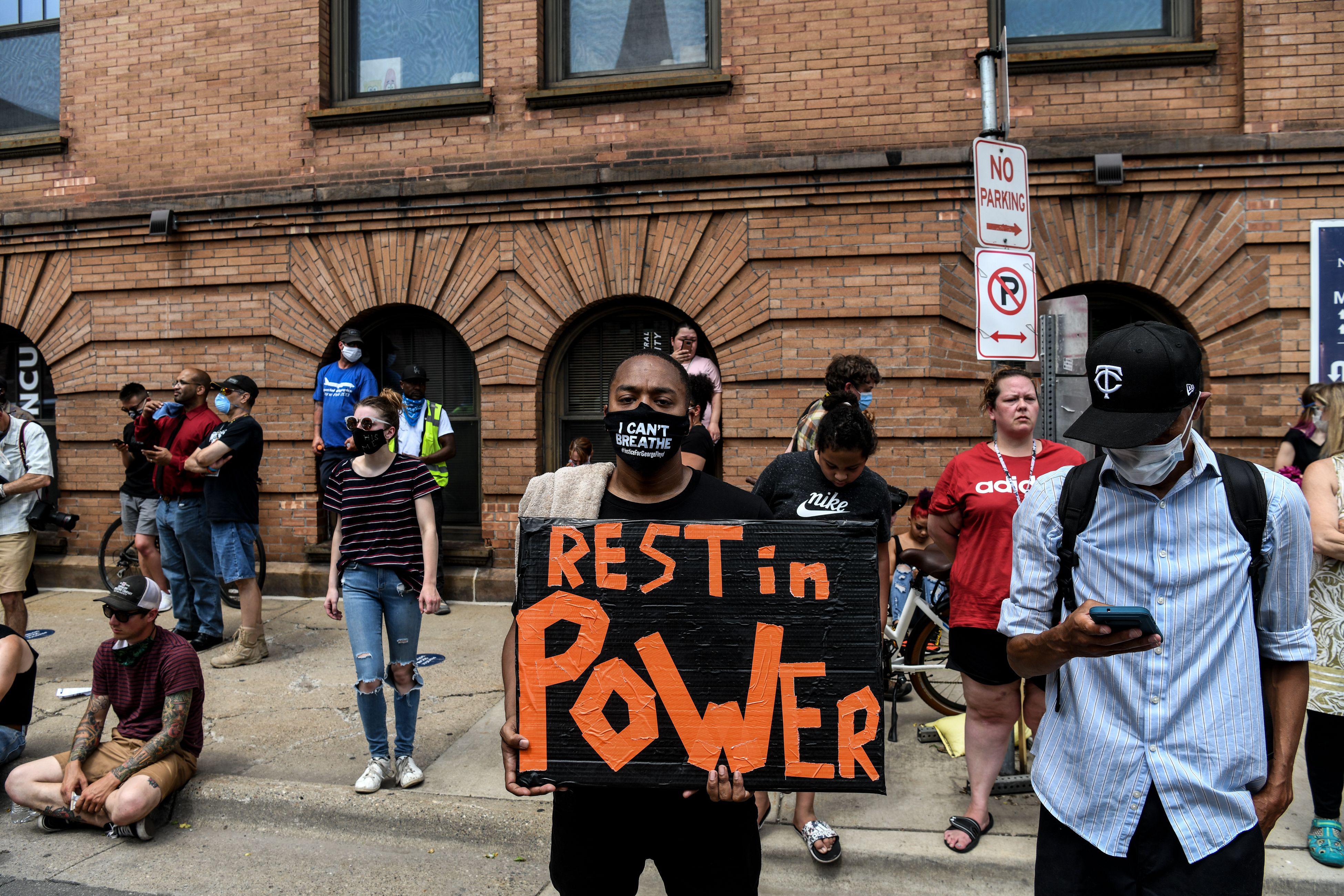 People gather outside of the memorial service in honor of George Floyd on June 4, 2020, in Minneapolis, Minnesota. - On May 25, 2020, Floyd, a 46-year-old black man suspected of passing a counterfeit $20 bill, died in Minneapolis after Derek Chauvin, a white police officer, pressed his knee to Floyd's neck for almost nine minutes. (Photo by CHANDAN KHANNA / AFP) (Photo by CHANDAN KHANNA/AFP via Getty Images)