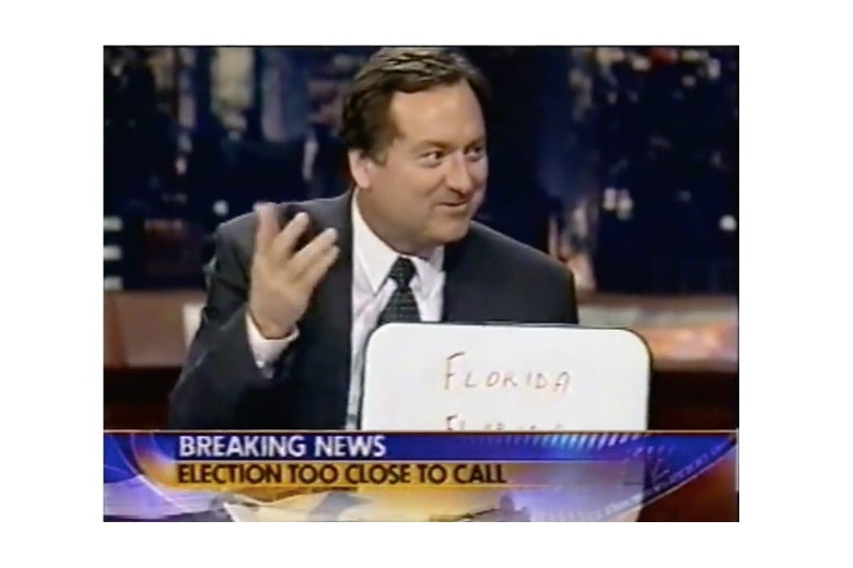 Russert holding a whiteboard.
