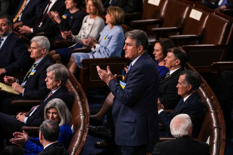 Manchin standing and clapping in the audience in the House chamber
