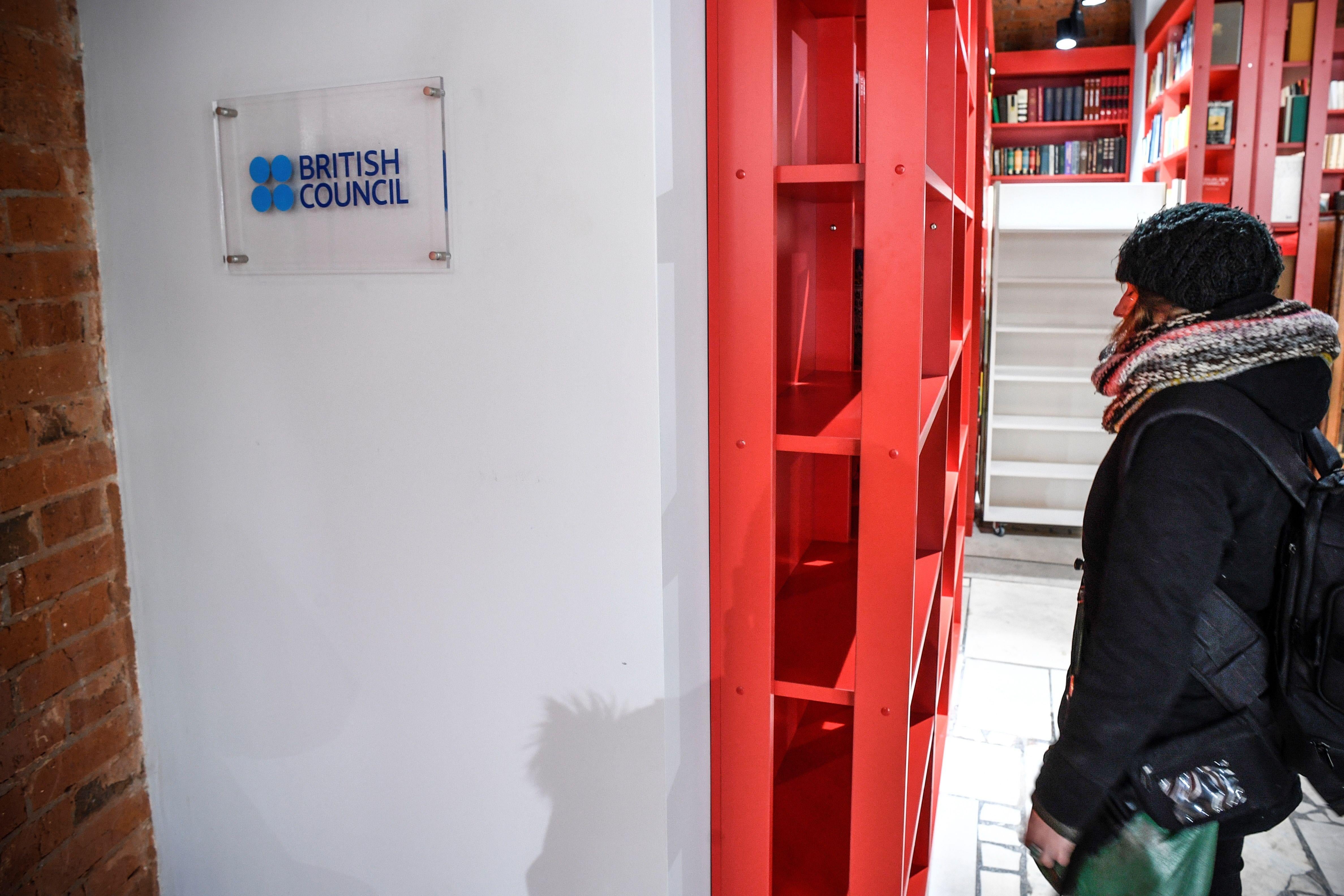 A woman stands next to the entrance of the British Council office in Moscow on March 2018.