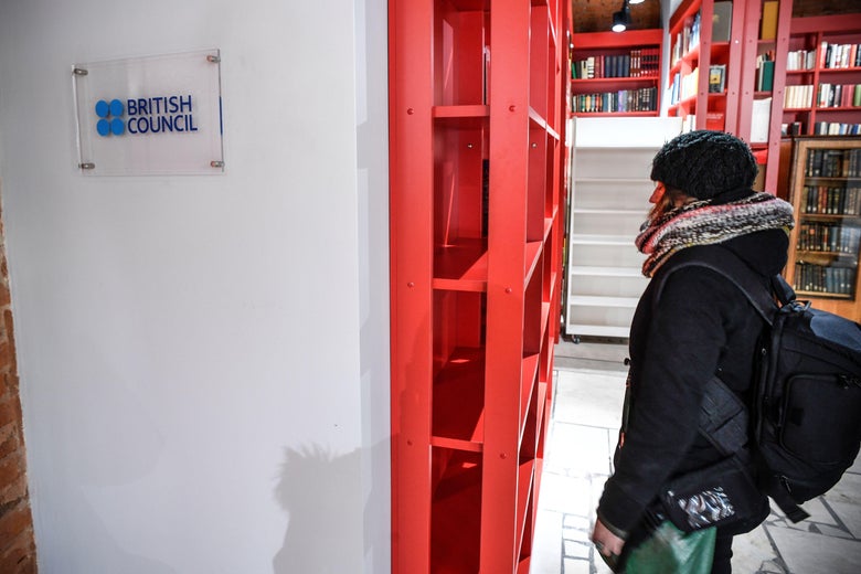 A woman stands next to the entrance of the British Council office in Moscow on March 2018.