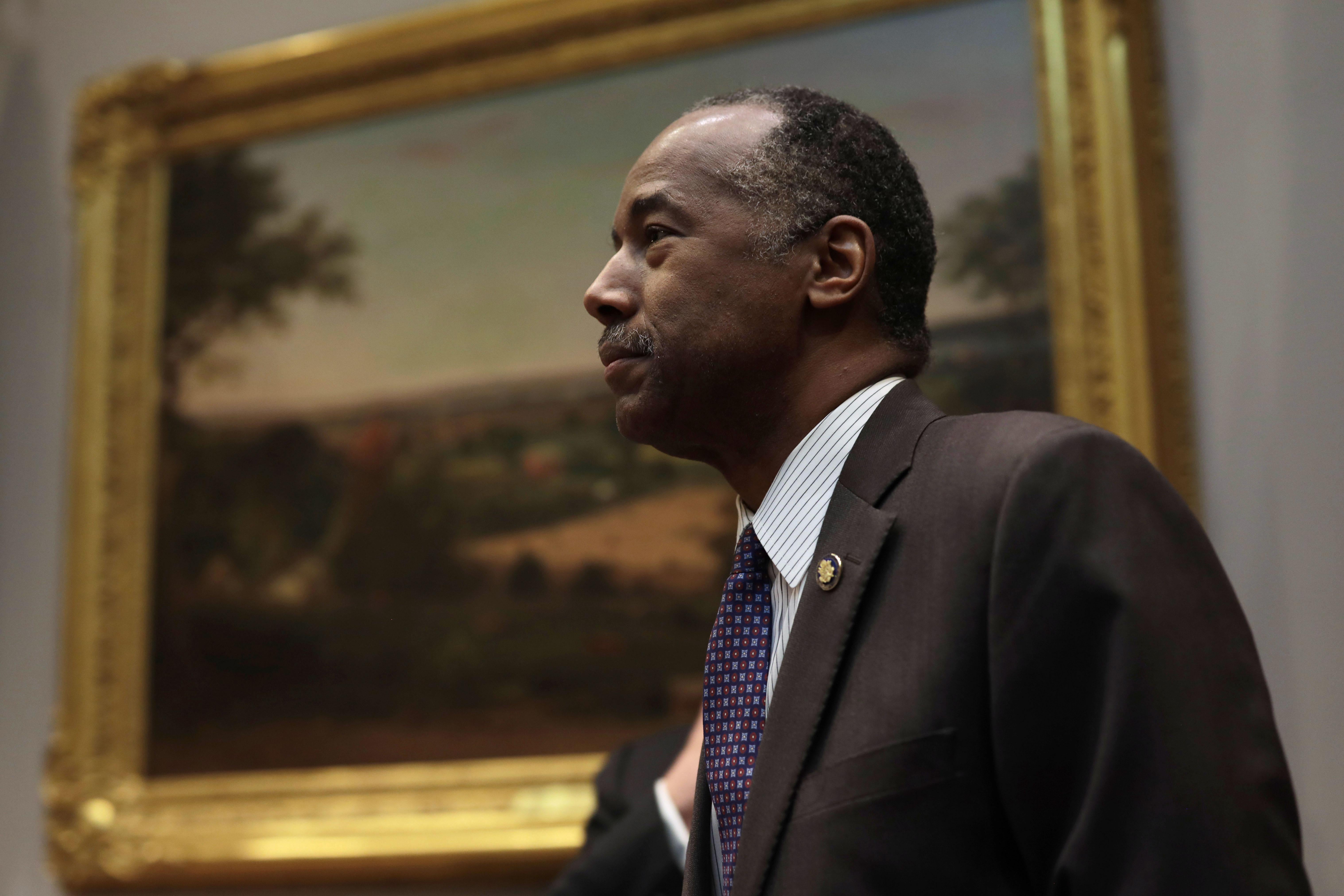 Ben Carson standing by a painting in the White House.
