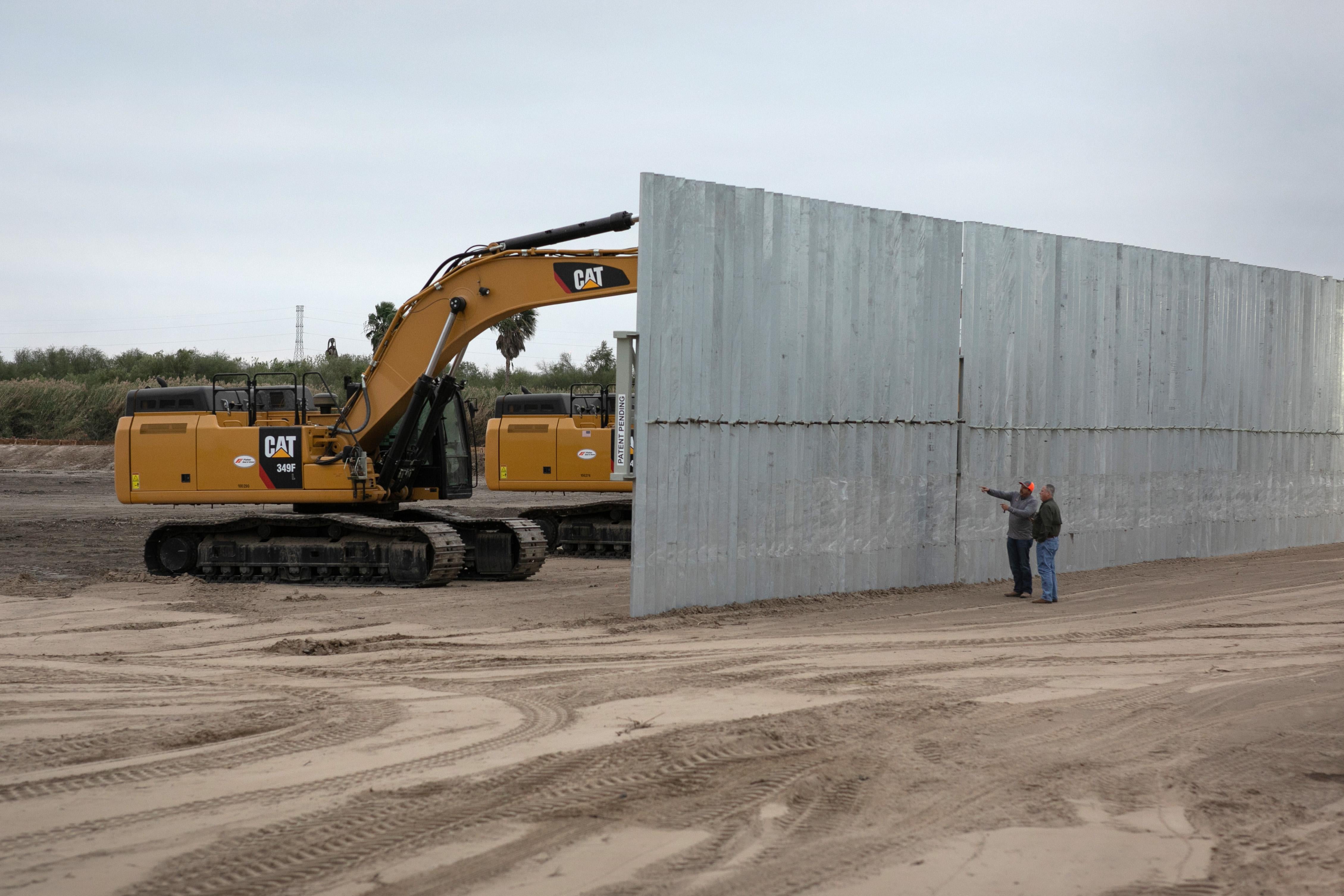 A construction crew works on a section of privately built border wall on December 11, 2019 near Mission, Texas. 