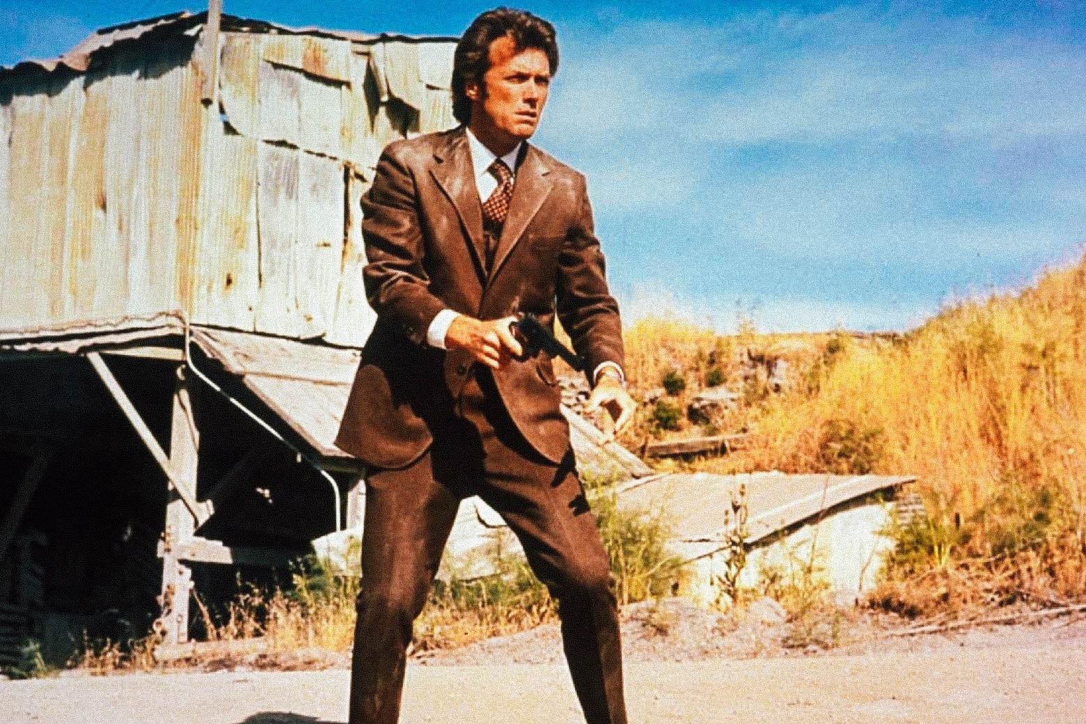 Clint Eastwood as Dirty Harry, standing outside, holding a handgun