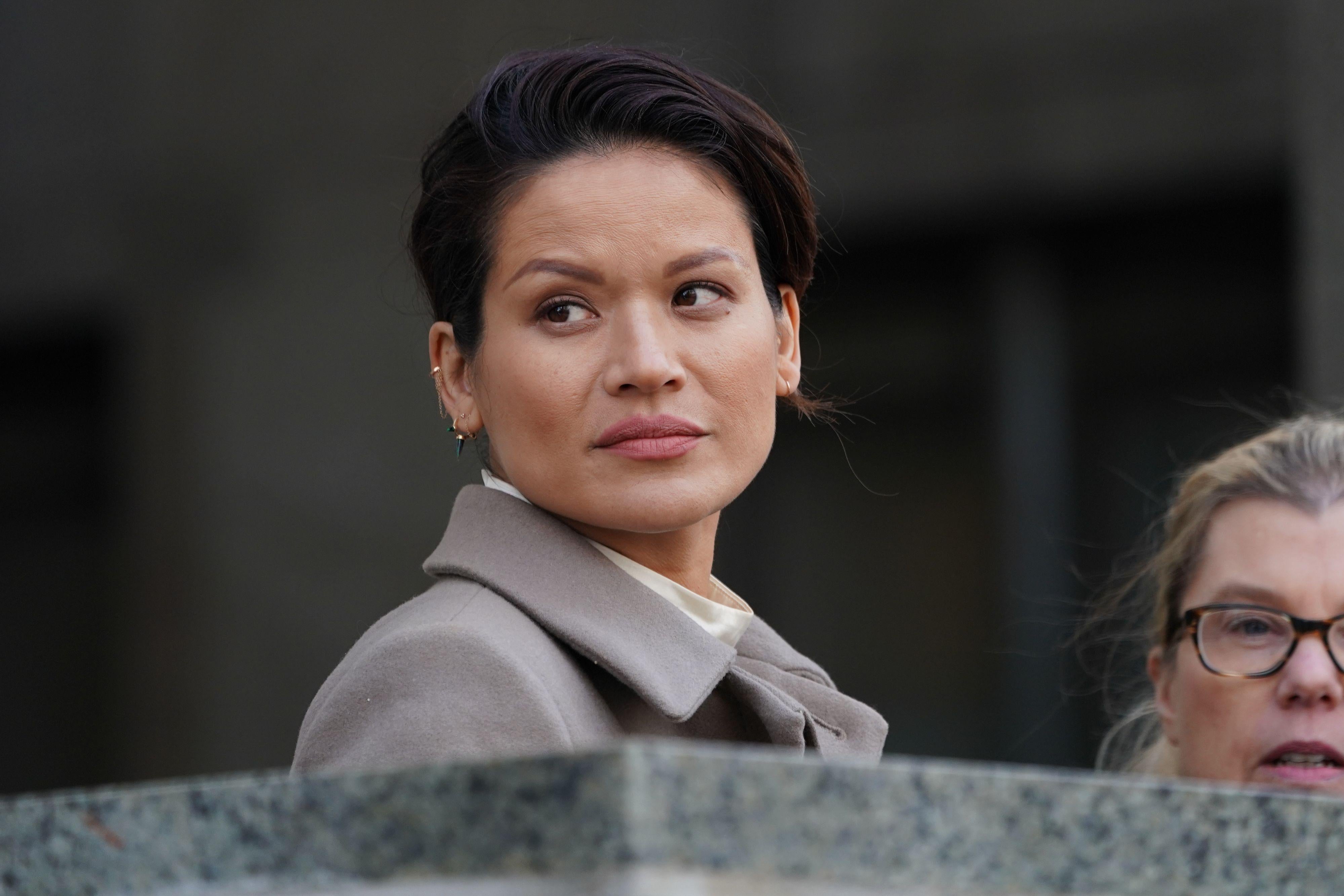 Tarale Wulff looks to her right, her head and shoulders visible above a granity ledge, with another woman in the background.
