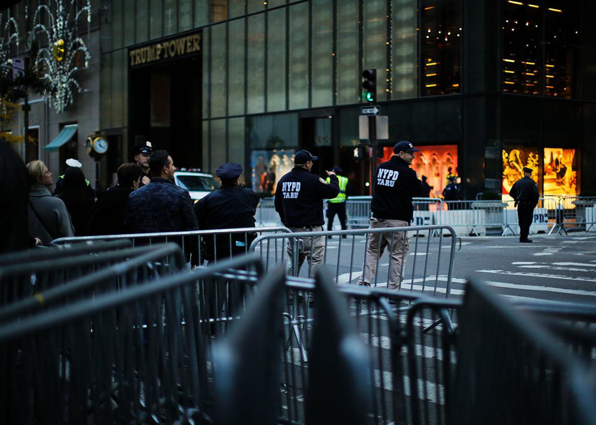 People walk through 5th Avenue near Trump Tower after the street was closed to foot traffic by police with barricades and officers at the entrance to the block at both ends for more than two weeks in New York on November 18, 2016.