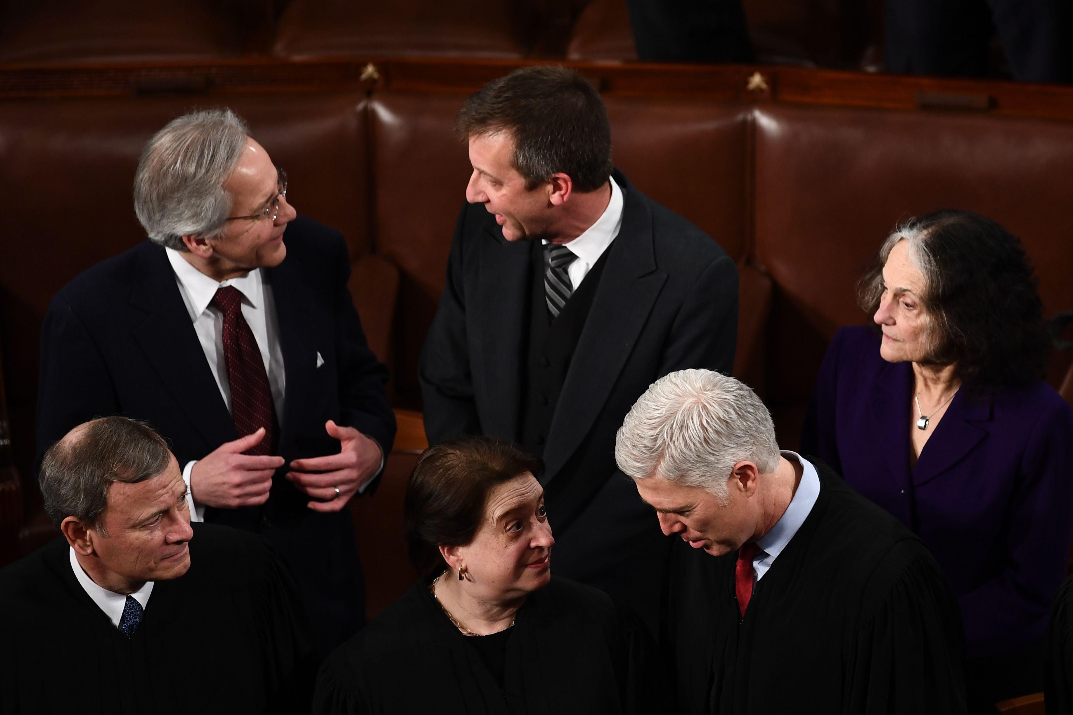 Kagan speaks to Gorsuch as Roberts looks on