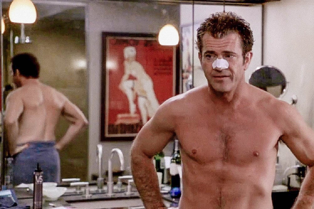 Mel Gibson in What Women Want.  Still from What Women Want where Mel Gibson is seen shirtless, from the torso up, in a bathroom, wearing a pore strip on his nose.