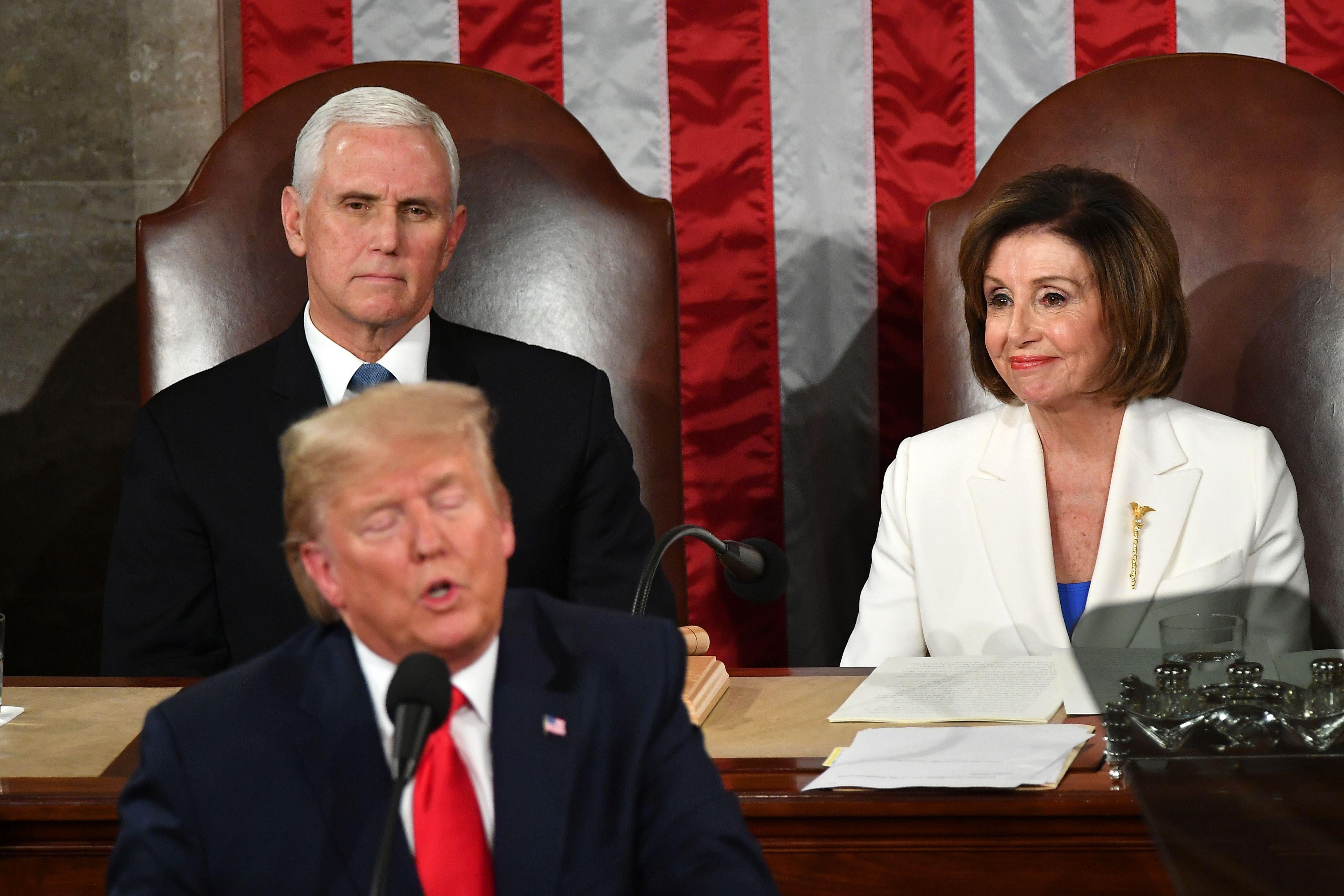Mike Pence and Nancy Pelosi seated behind Donald Trump as he delivers the State of the Union address.