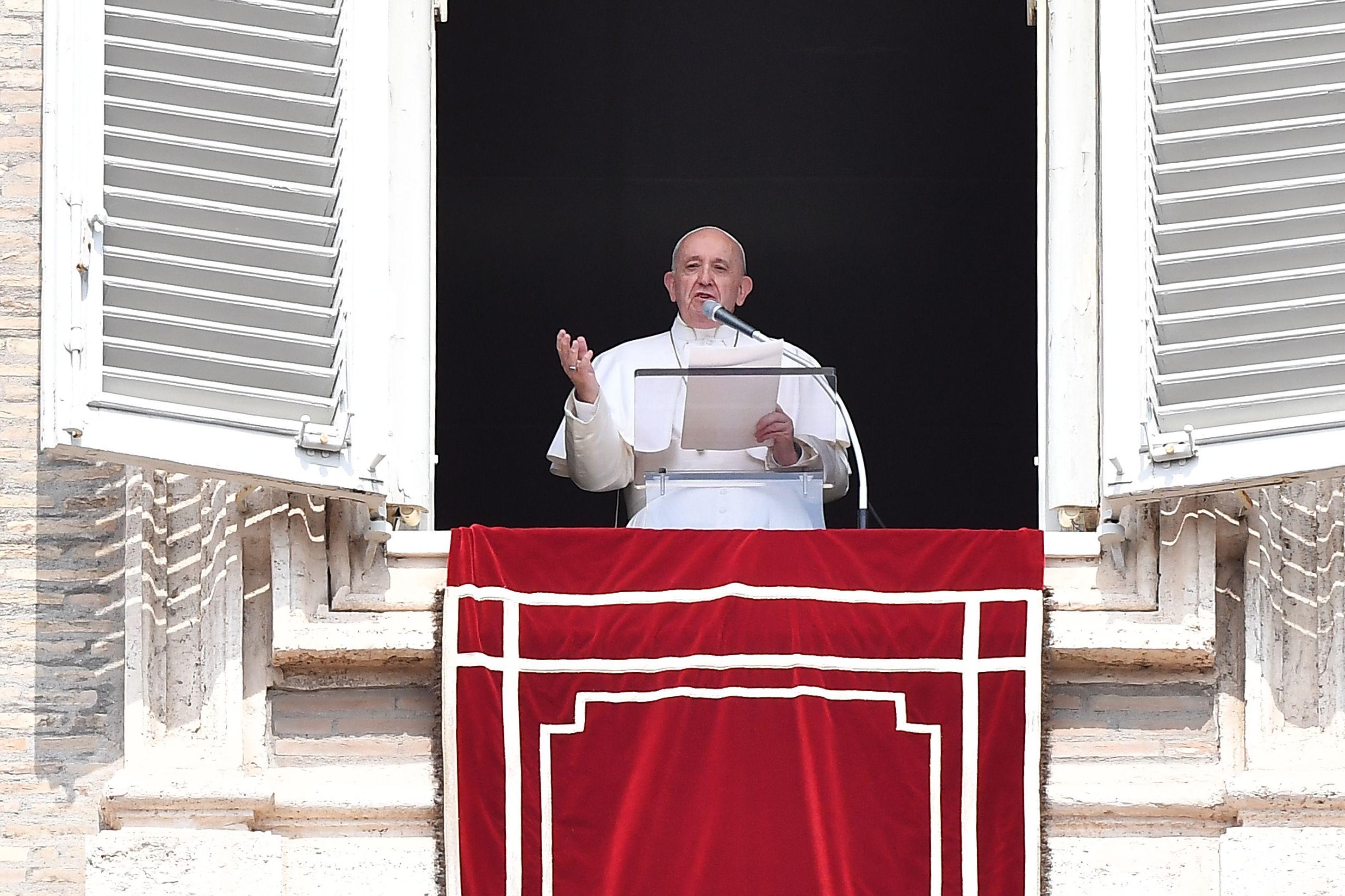 Pope Francis speaks from the window of the apostolic palace after being freed from his elevator.