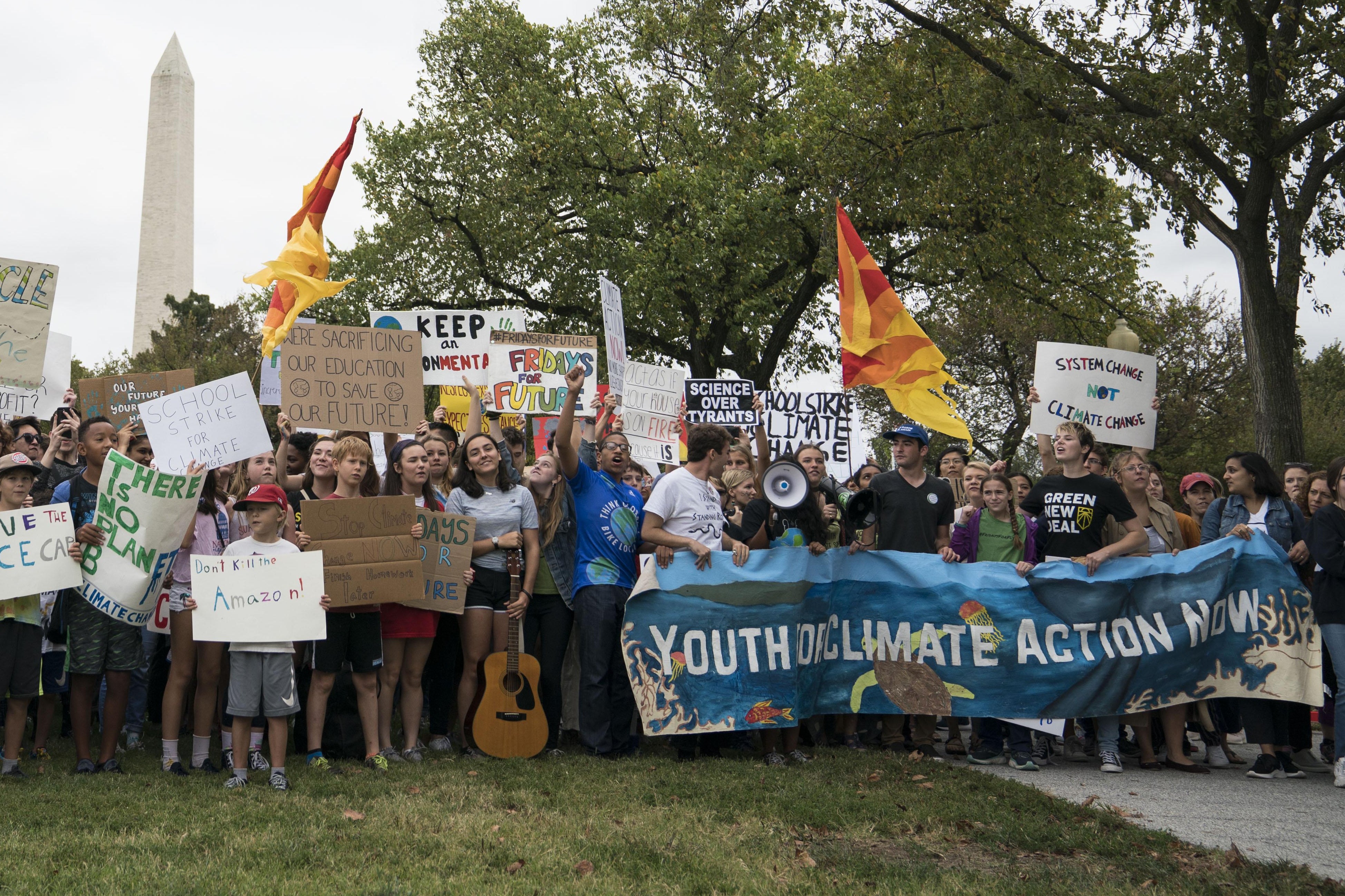 Student environmental advocates participate in a strike to demand that action be taken on climate change outside the White House.