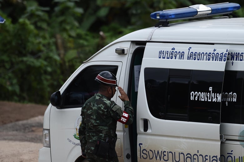A Thai military police officer salutes an ambulance