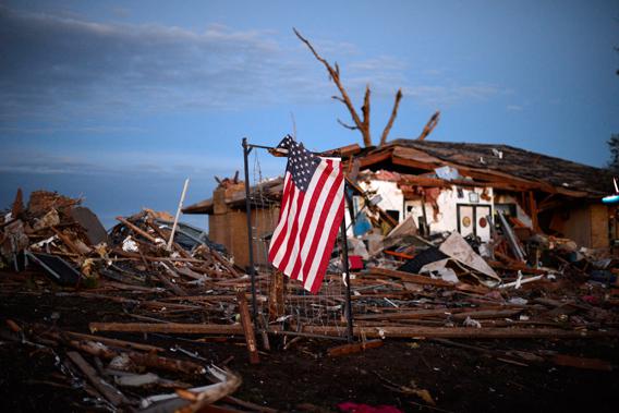 A U.S. flag is seen amongst the debris of a torando devastated house on May 21, 2013 in Moore, Oklahoma. 