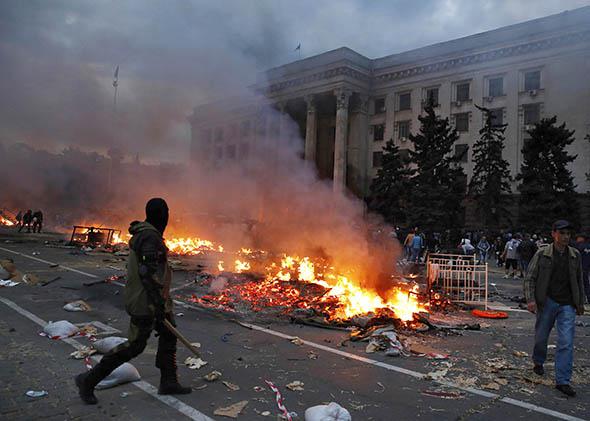 A protester walks past a burning pro-Russian tent camp near the trade union building in Odessa May 2, 2014.
