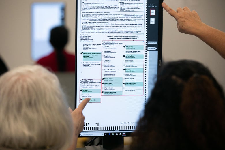 Members of the Gwinnett County adjudication review panel look over remaining scanned ballots.