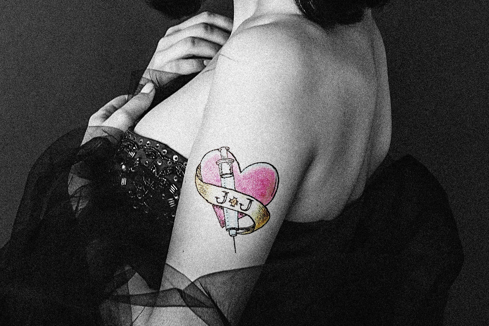 A tattoo of a heart around J & J