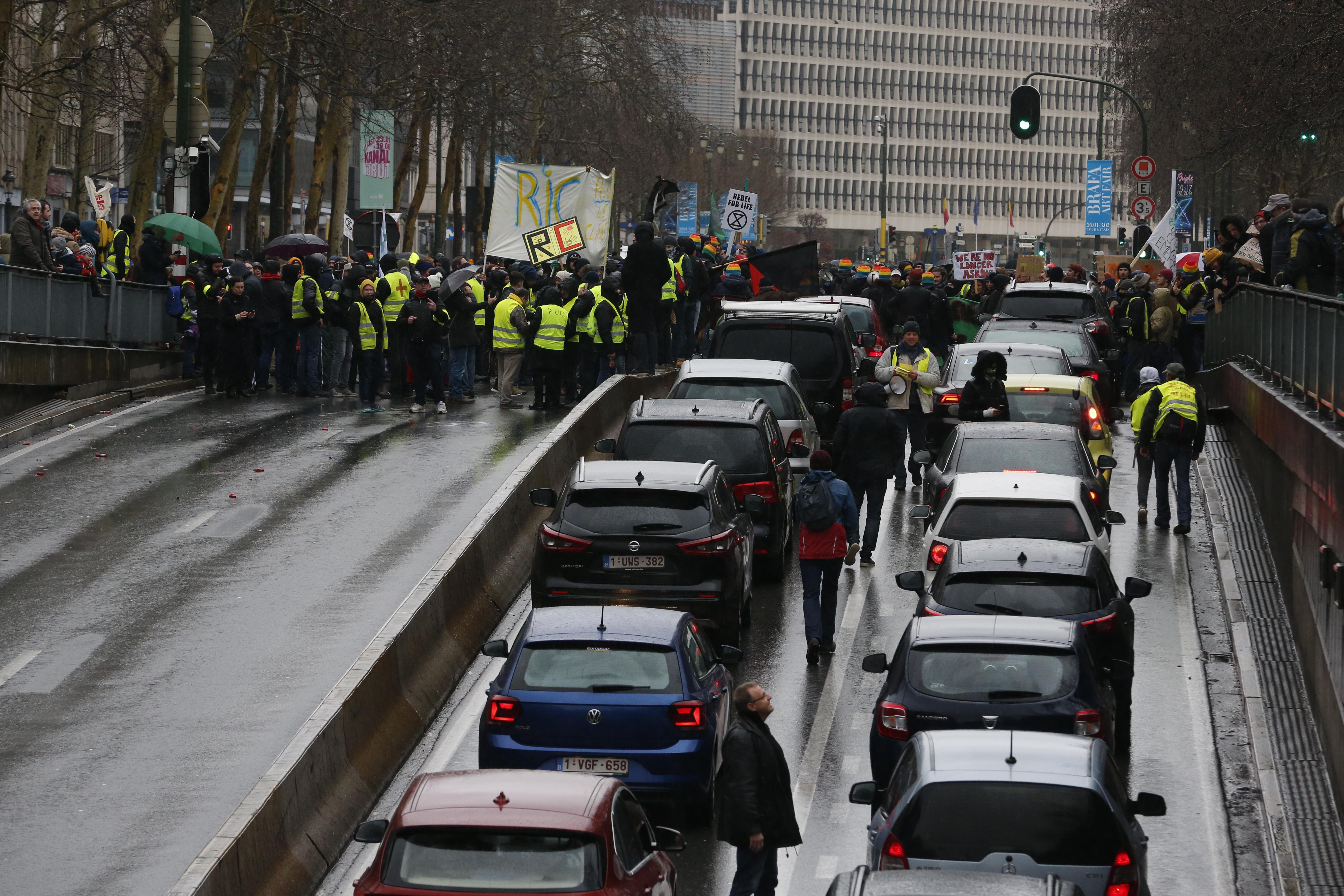 A traffic jam takes place outside a climate change awareness demonstration in Brussels.