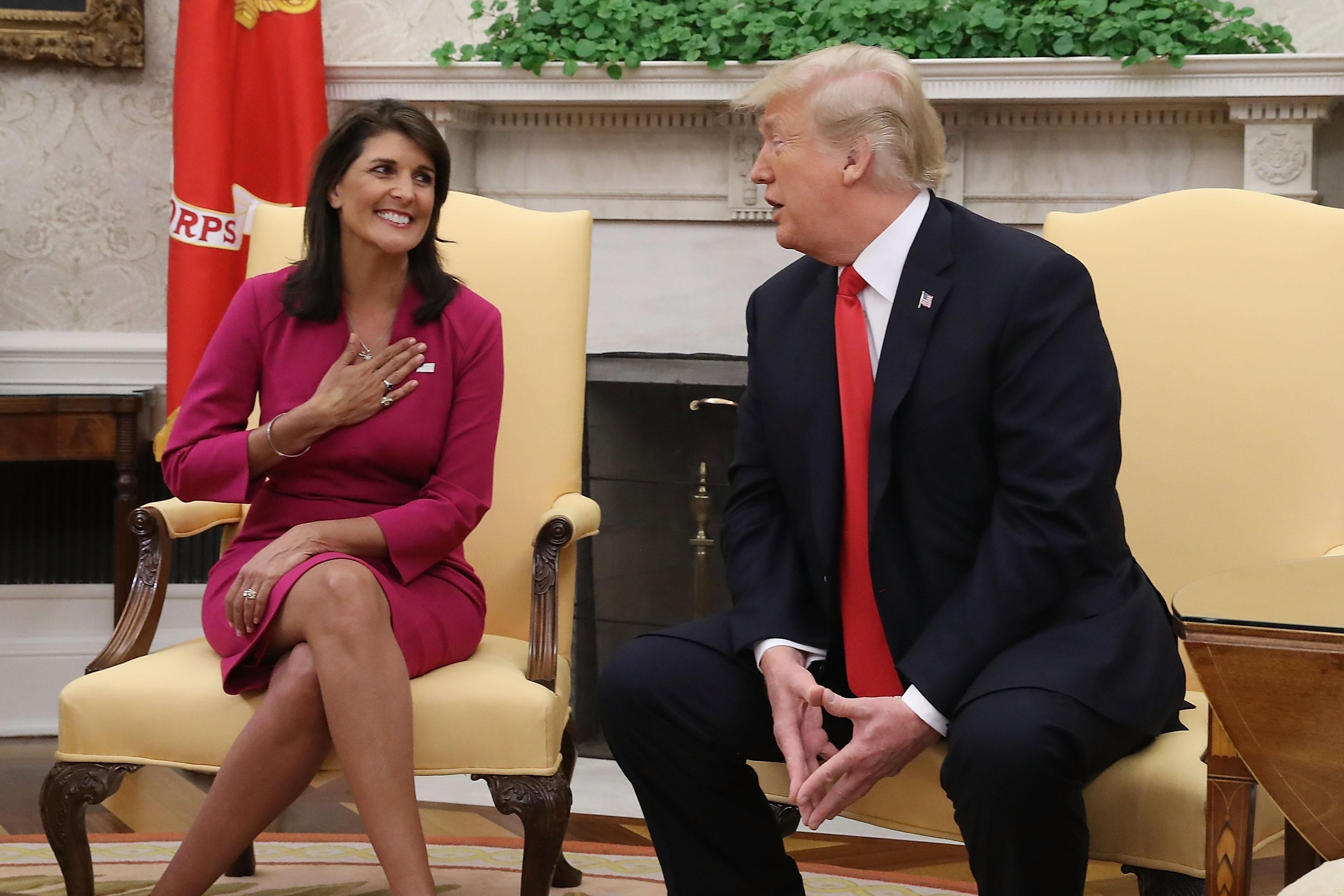 President Donald Trump sits next to Nikki Haley in the Oval Office.