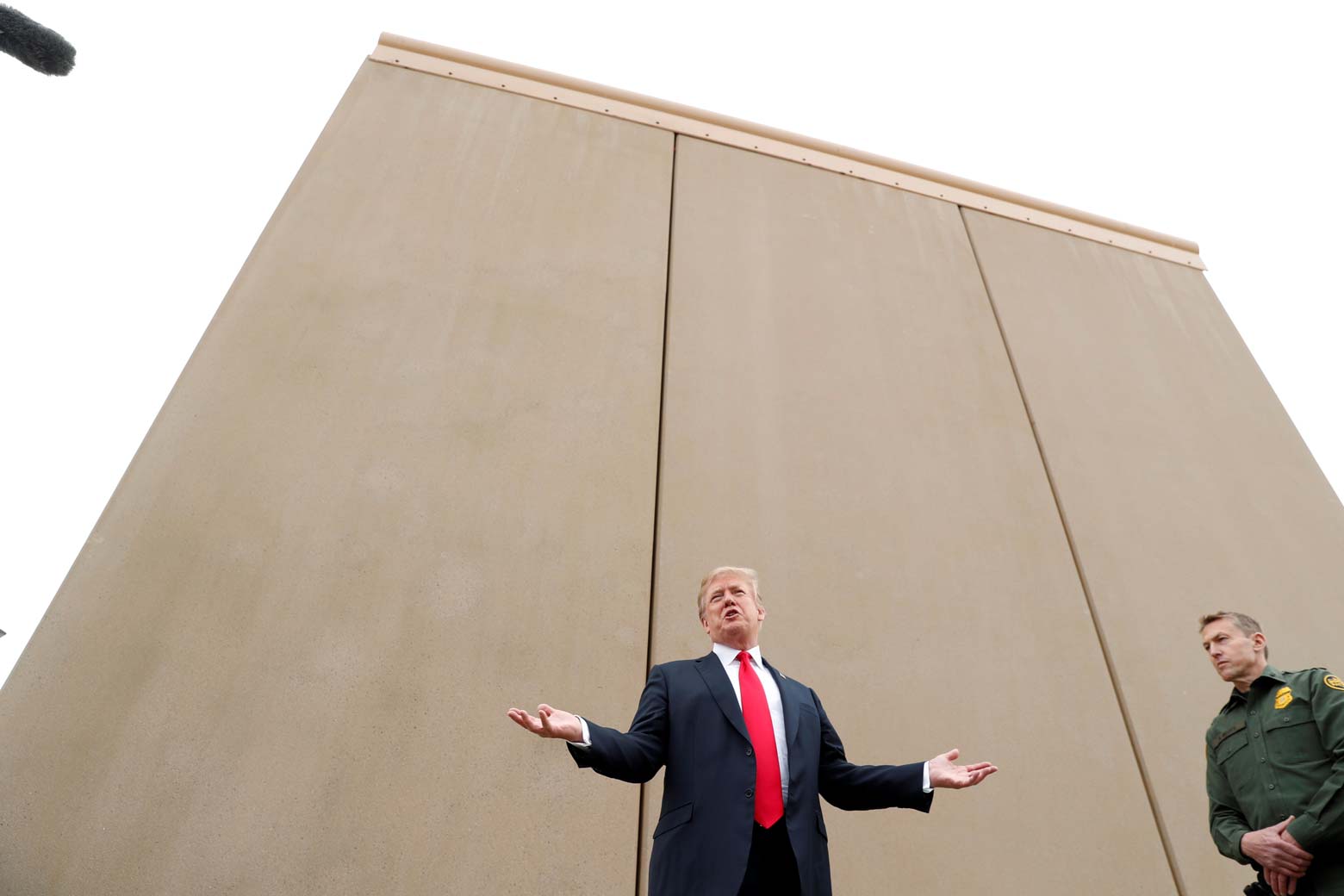 President Donald Trump speaks while participating in a tour of U.S.-Mexico border-wall prototypes.