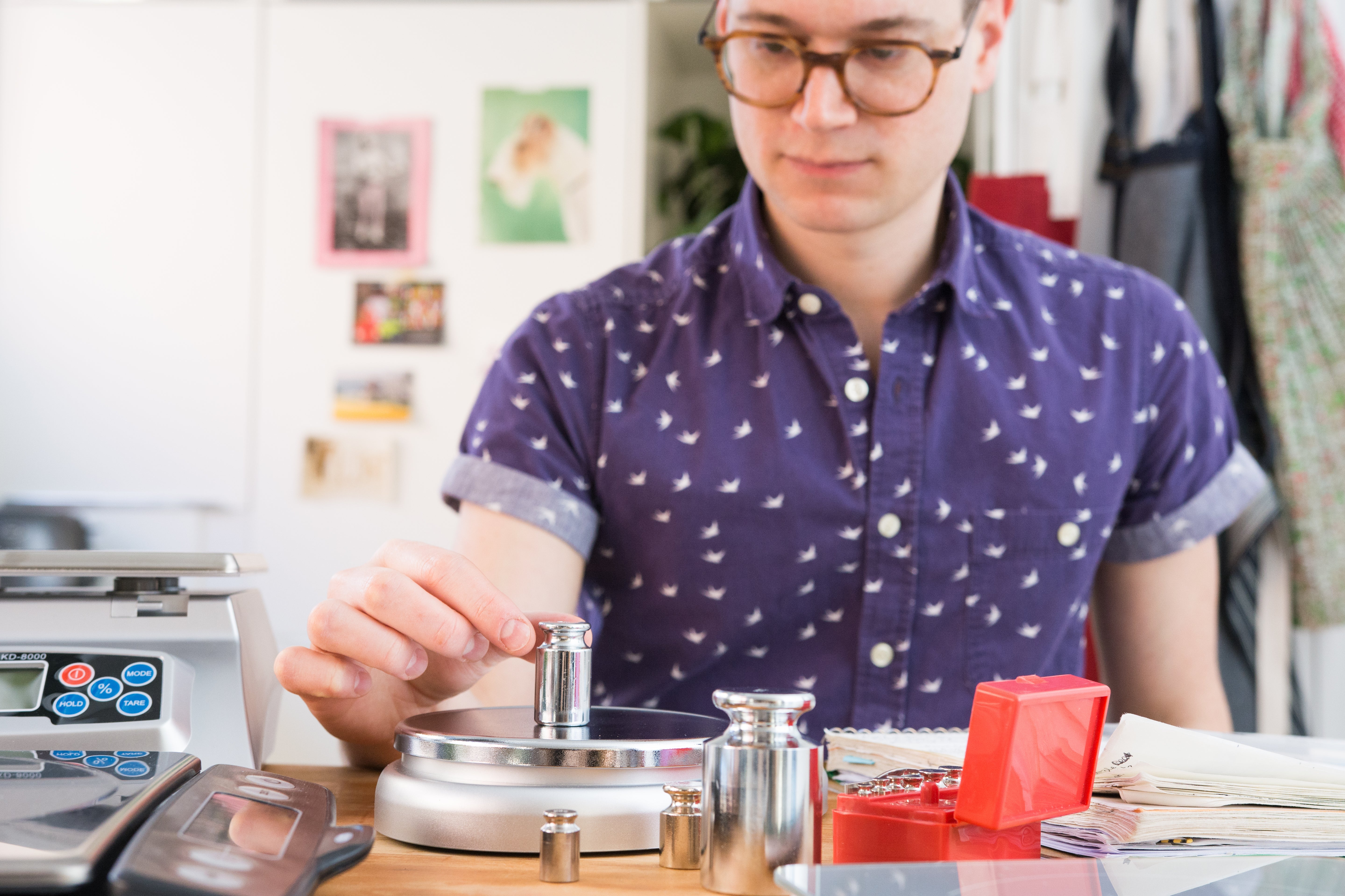 man putting weights on a kitchen scale