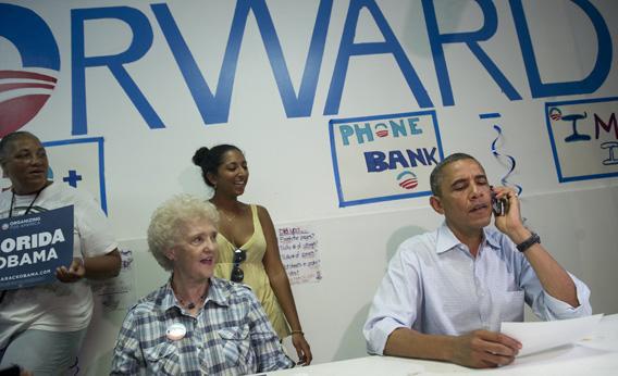 Obama makes a phone call to a supporter during a visit to the Obama for American campaign field office