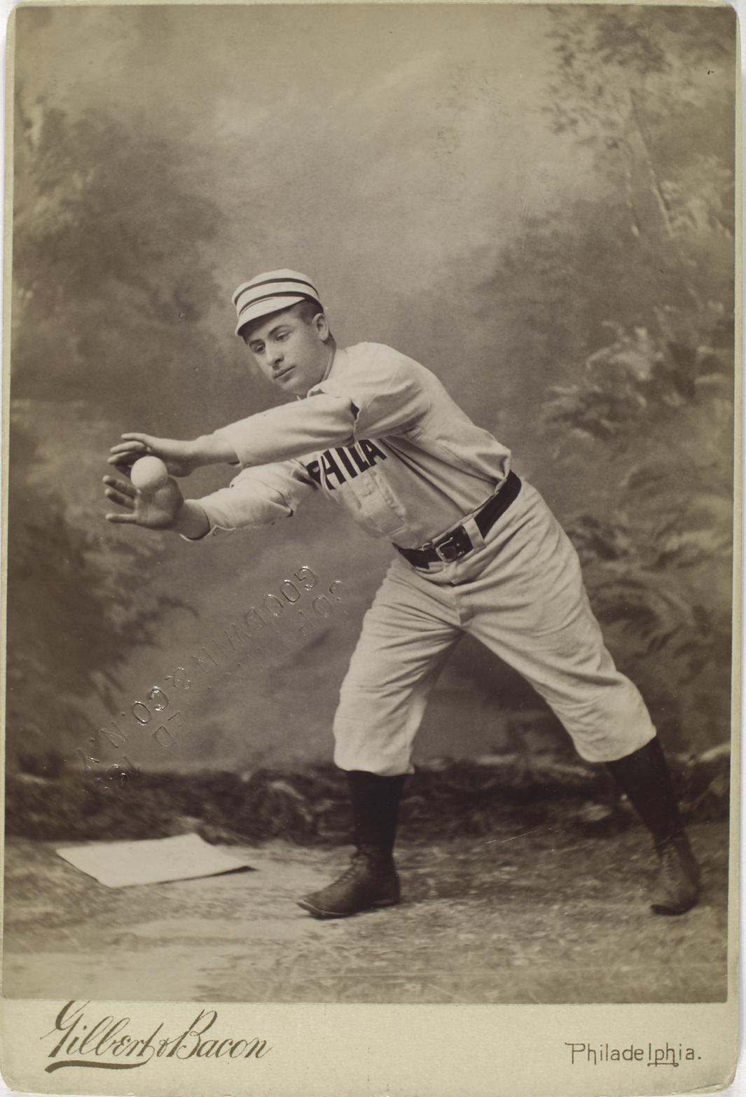 OLD BETHPAGE, NEW YORK - MAY 22, 2016: Baseball Player In 19th Century Vintage  Uniform During Old Style Base Ball Play Following The Rules And Customs  From 1864 In Old Bethpage Village