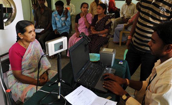 An Indian villager looks at an Iris scanner during the data collecting process.