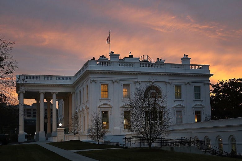 The White House is seen from the side at dawn.