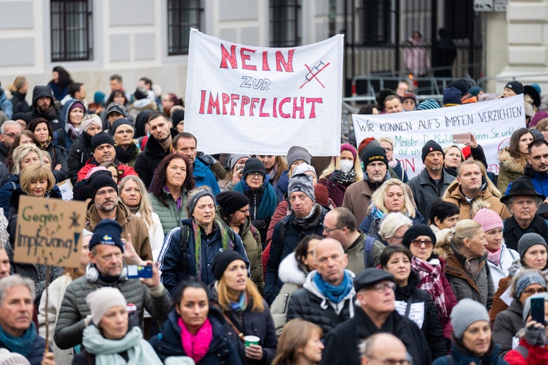 A demonstrator holds a placard reading "No to compulsory vaccination" during an anti-vaccination protest at the Ballhausplatz in Vienna, Austria on November 14, 2021.