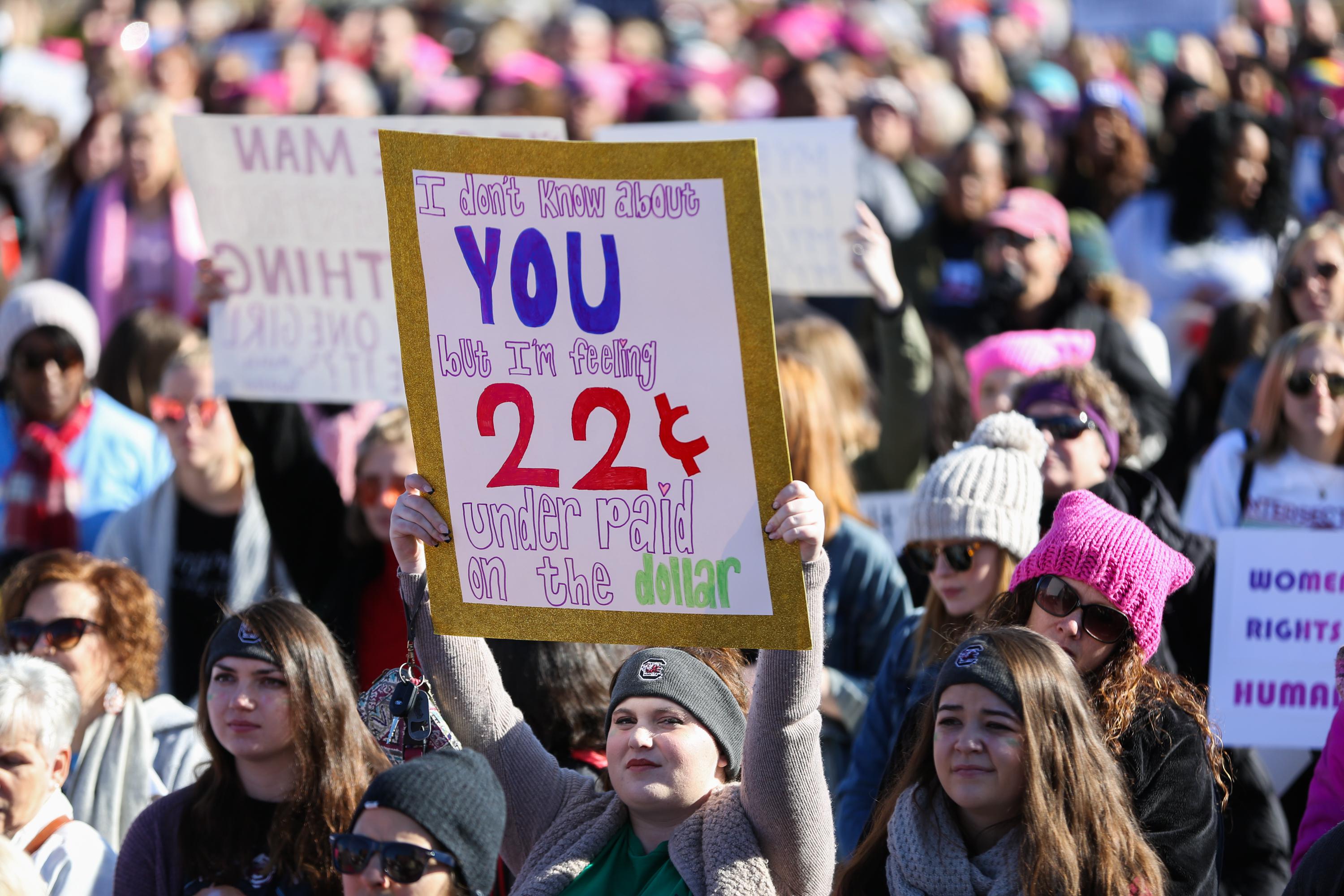 A woman holds a sign in First Ward Park as she takes part in the Remarchable Women rally in Charlotte, North Carolina on January 20, 2018, marking the one-year anniversary of the Women's March. 