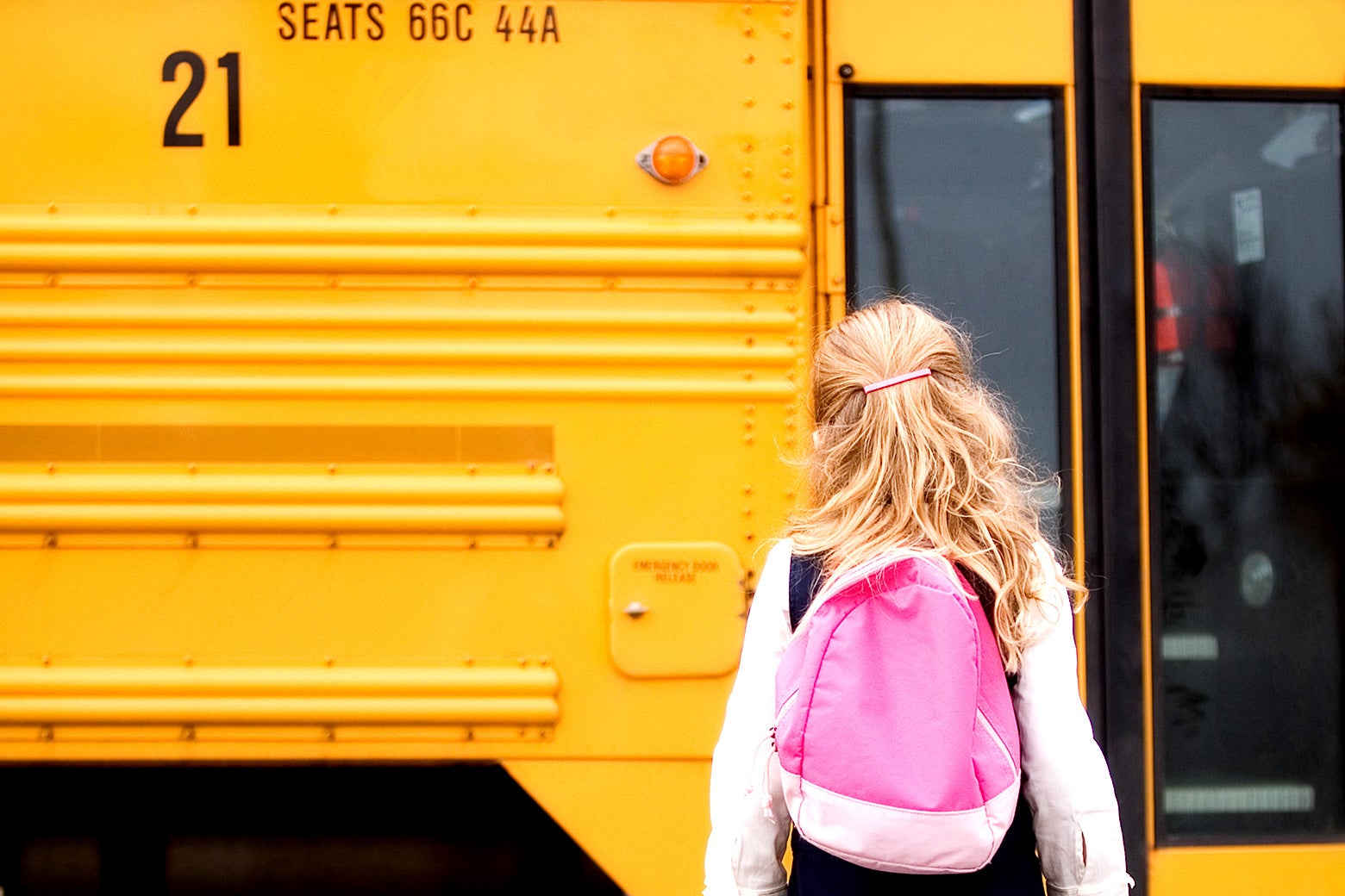 A girl walking to a school bus