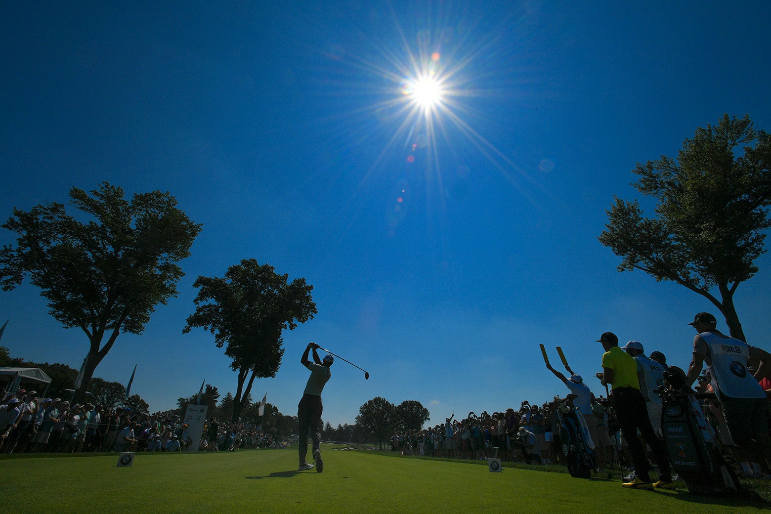 Tiger Woods plays a tee shot on the 11th hole during the first round of the BMW Championship.
