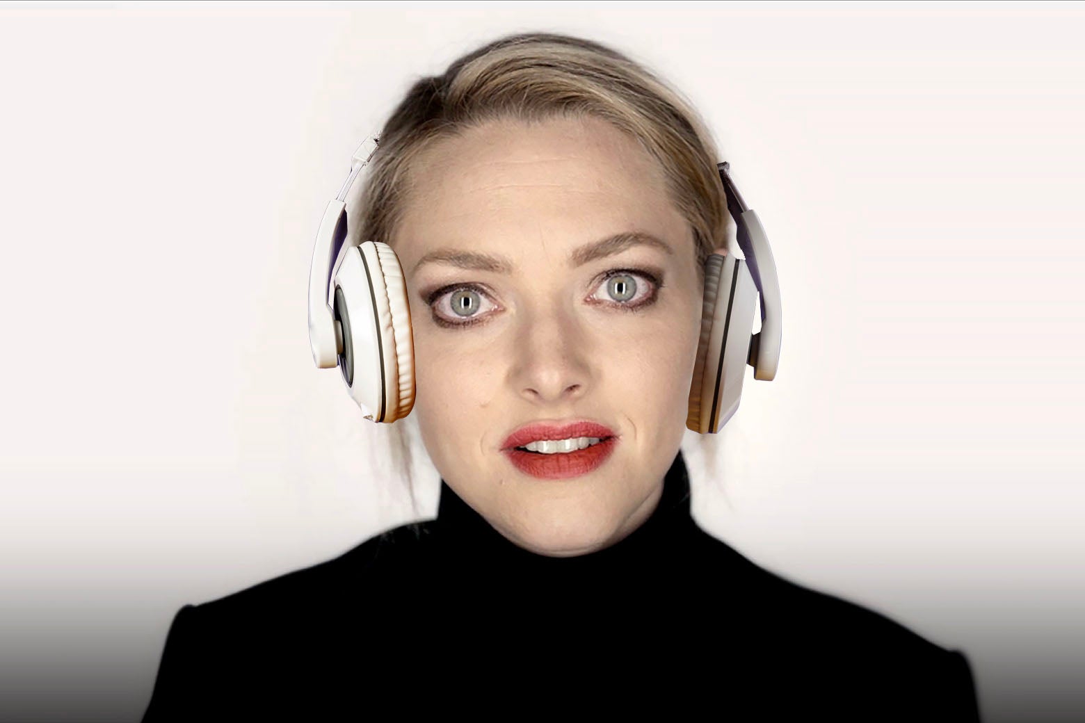 Amanda Seyfried as Elizabeth Holmes, staring directly into the camera in her signature black turtleneck, her eyes glassy, a pair of Beats headphones photoshopped onto her head