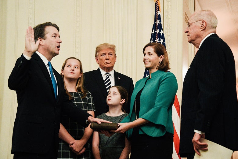 Ashley Kavanaugh holds the Bible on which Brett Kavanaugh places his hand as he’s sworn in to the Supreme Court. Their children, Donald Trump, and retired Justice Anthony Kennedy are also there.