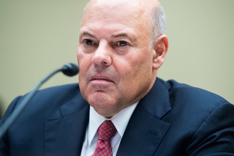 Louis DeJoy behind a microphone at the hearing.