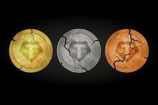 A gold Tether coin, a silver Tether coin, and a bronze Tether coin, all with varying amounts of cracks.