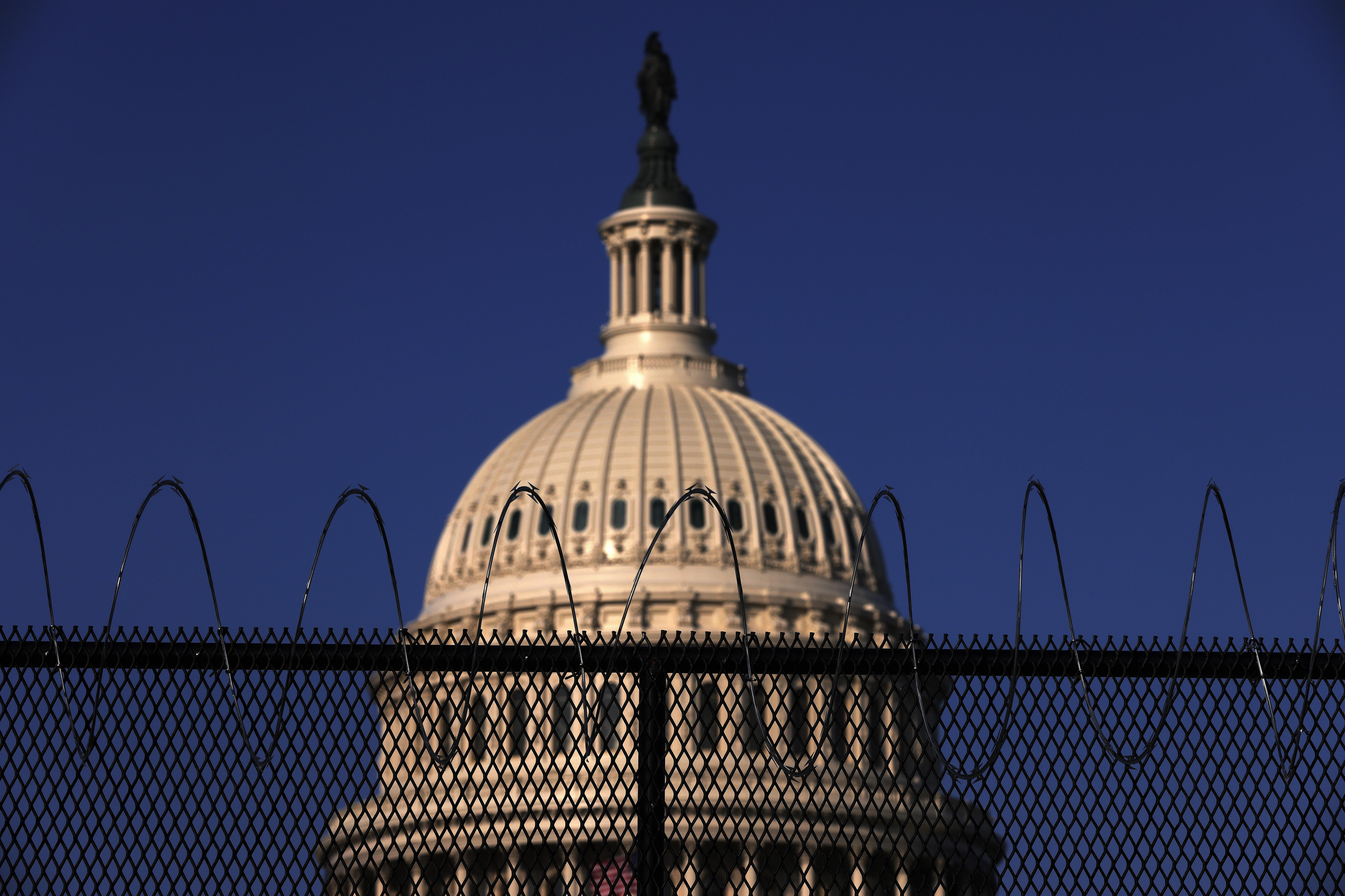 Razor wire is seen on the top of fencing that surrounds the Capitol.