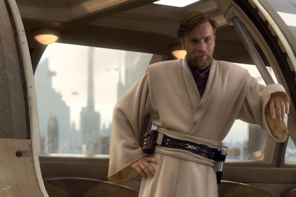 Ewan McGregor, as Obi-Wan Kenobi, leans against the doorway of a starship.