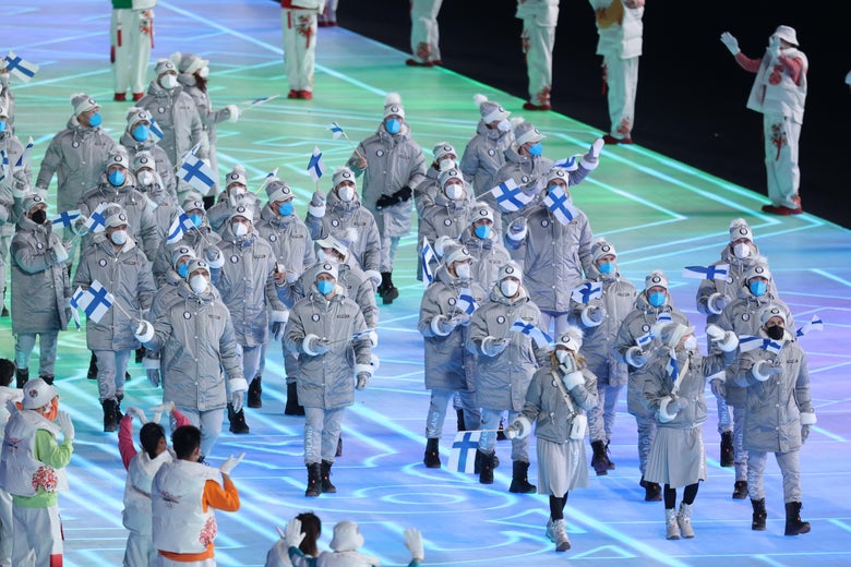 Members of Team Finland, in all gray, march in a group.
