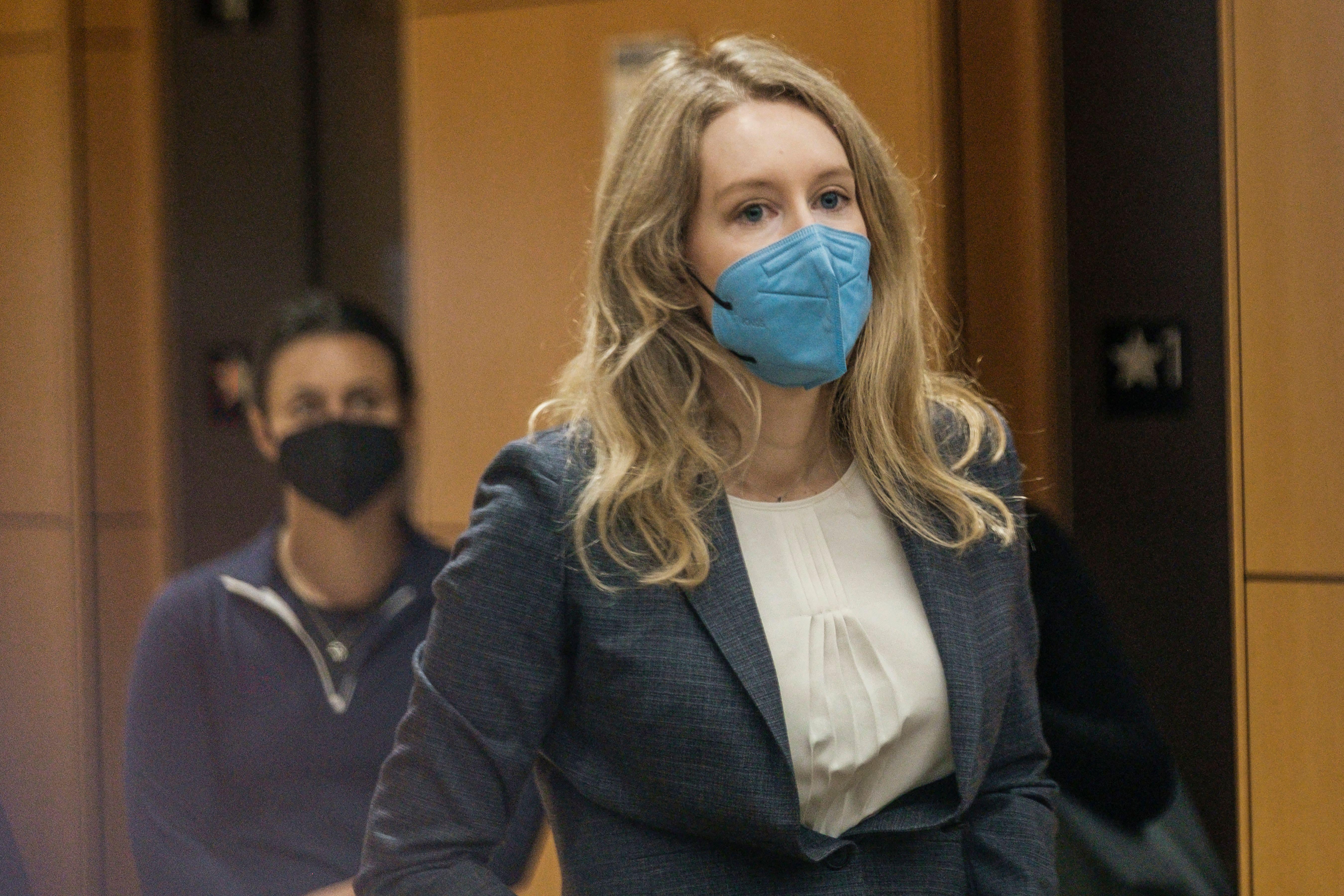 a blonde woman in a blue mask 