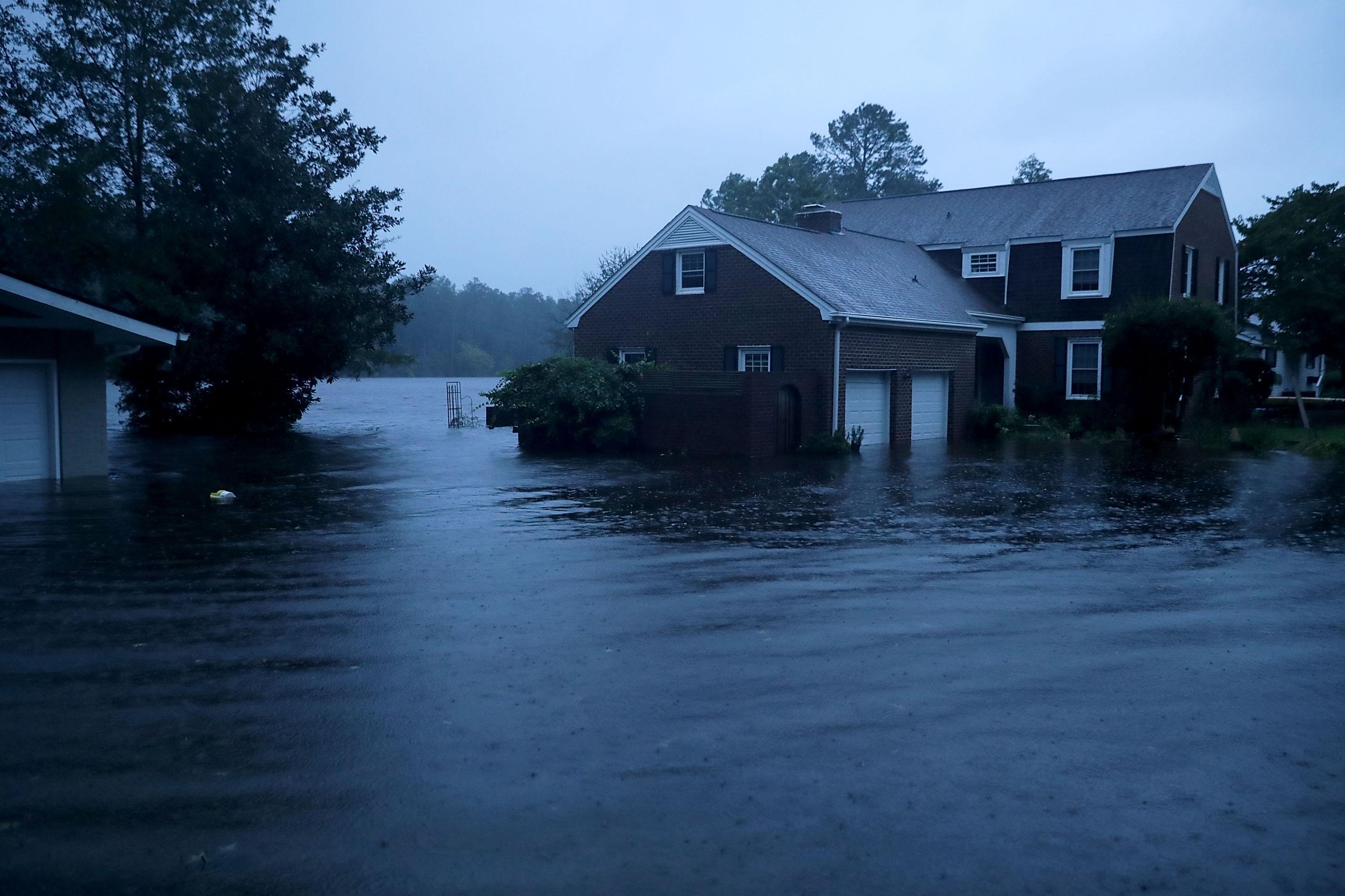 The Trent River (background) overflows its banks and floods a neighborhood during Hurricane Florence September 13, 2018 in River Bend, North Carolina. Some parts of River Bend and the neighboring New Bern could be flooded with a possible 9-foot storm surge as the Category 2 hurricane approaches the United States.  (Photo by Chip Somodevilla/Getty Images)