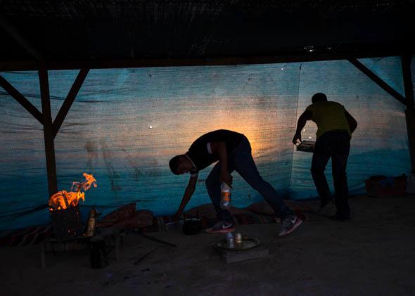 Bedouin youths are seen in their tent in the village of al-Arakib, one of the dozens of ramshackle Bedouin Arab communities in the Negev desert which are not recognized by the Israeli state, in southern Israel August 18, 2013.