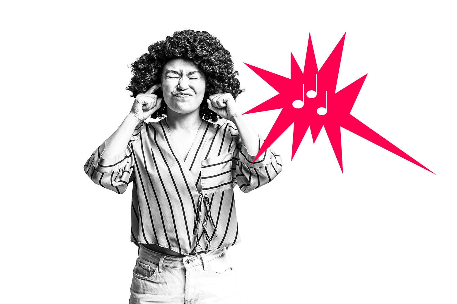 Woman covering her ears to block out sound.