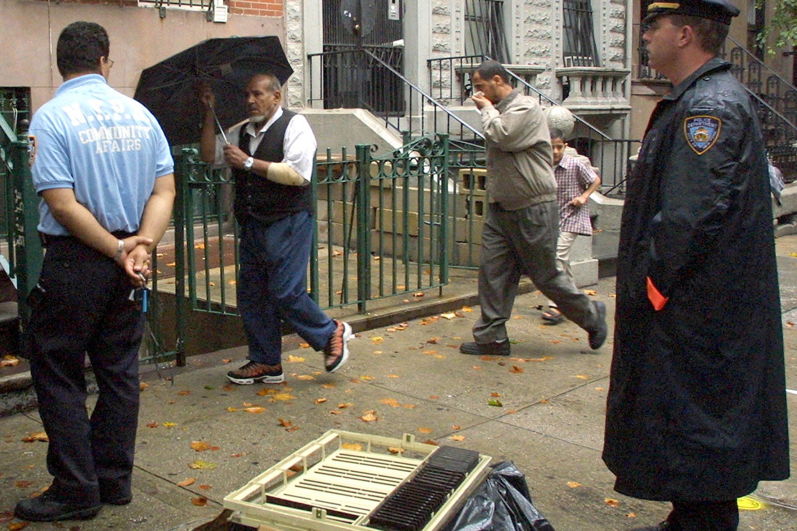 Worshippers at an Islamic center in the Brooklyn Heights neighborhood of Brooklyn, New York, pass a police officer dispatched for protection 14 September 2001. The officers were there as a precaution. 