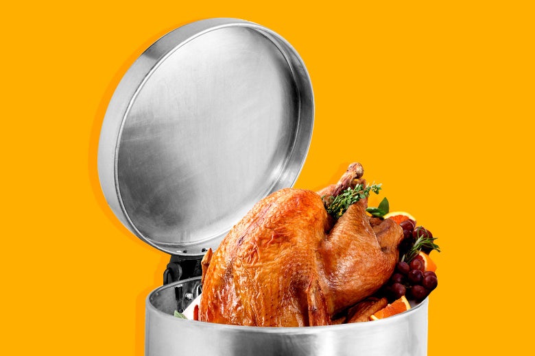 A glistening roasted Thanksgiving turkey sticking out of a trash can