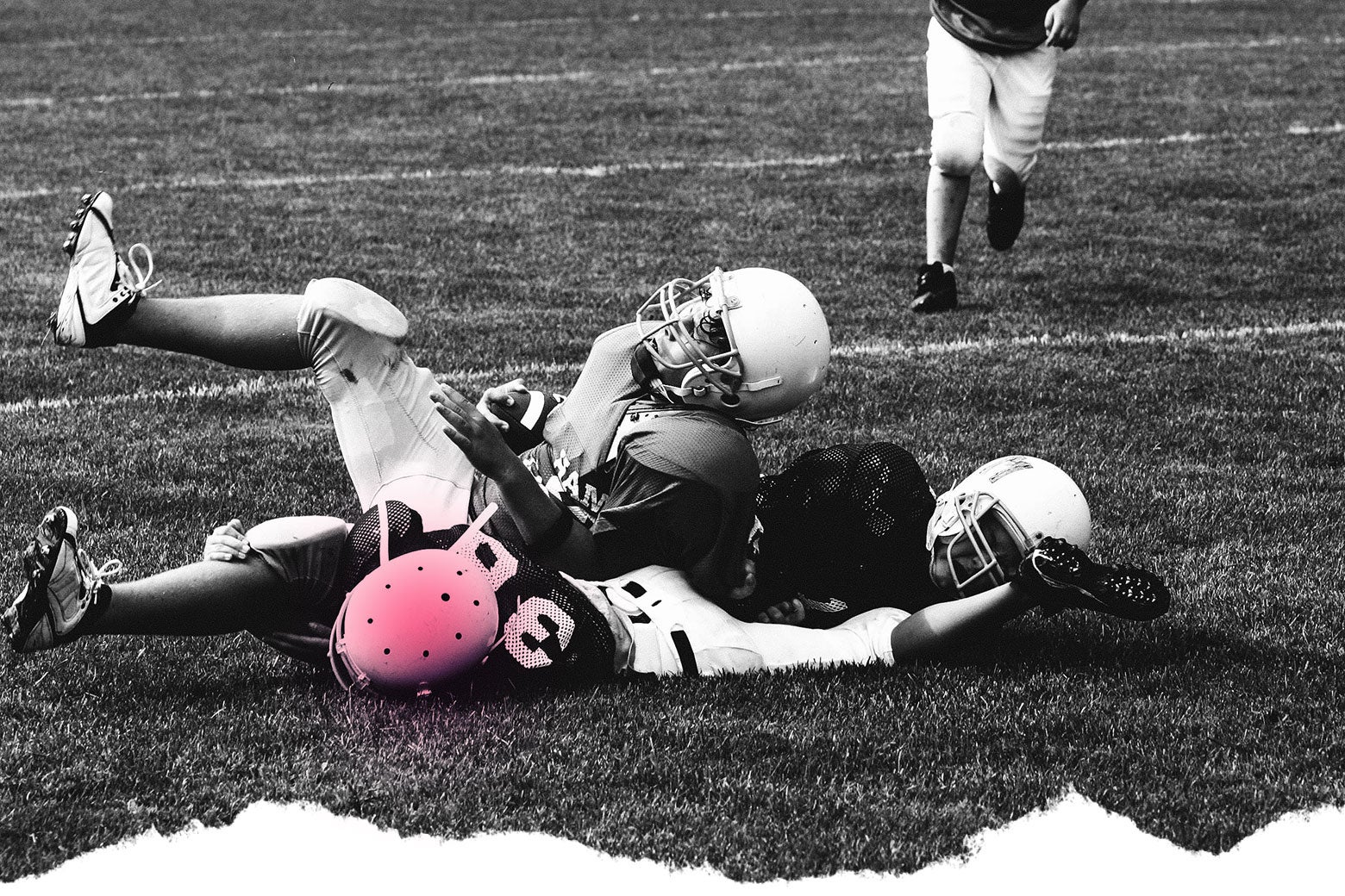 Photo illustration: A football player lies on the ground with his helmet highlighted to suggest a possible concussion.