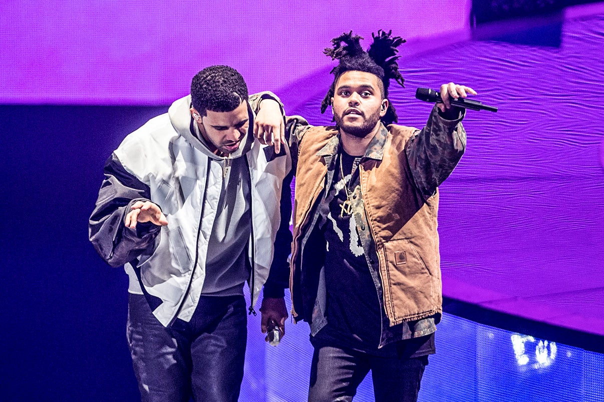 Drake and the Weeknd performing on a stage.