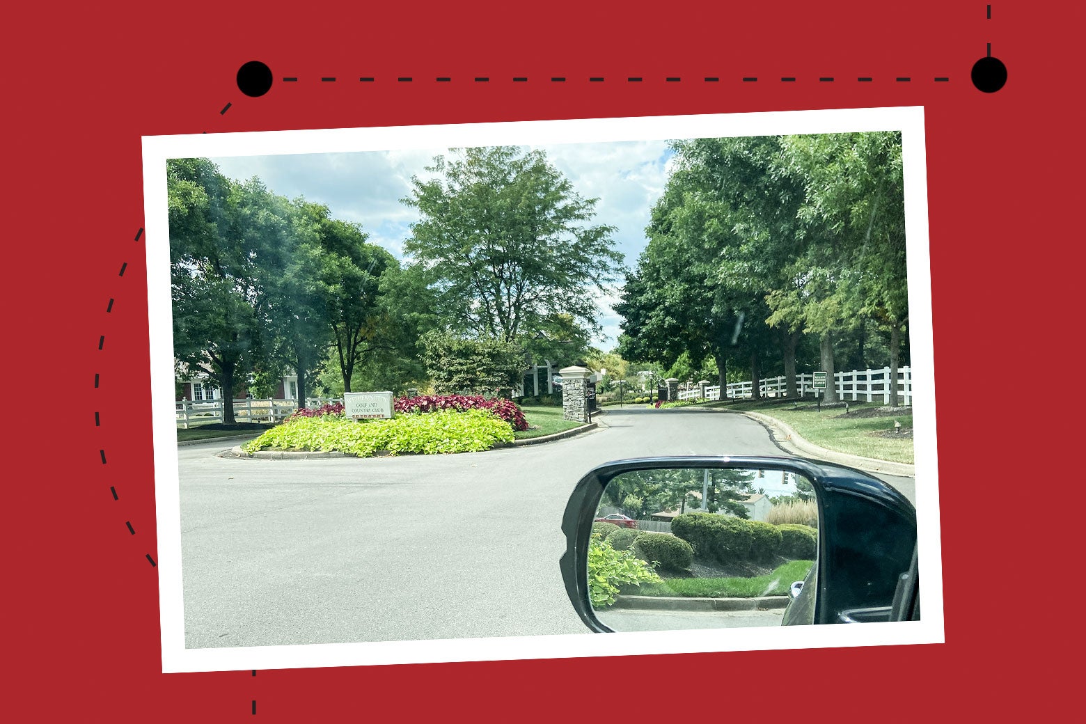 A fancy driveway seen out the window of a car.