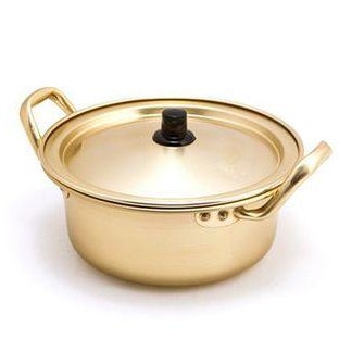 A gold-colored pot with two handles and a lid.