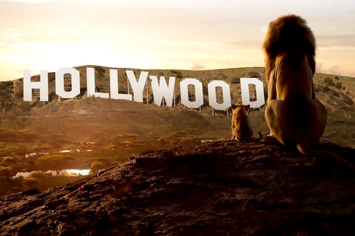 Mufasa and Simba sit on a rock overlooking the Hollywood sign.